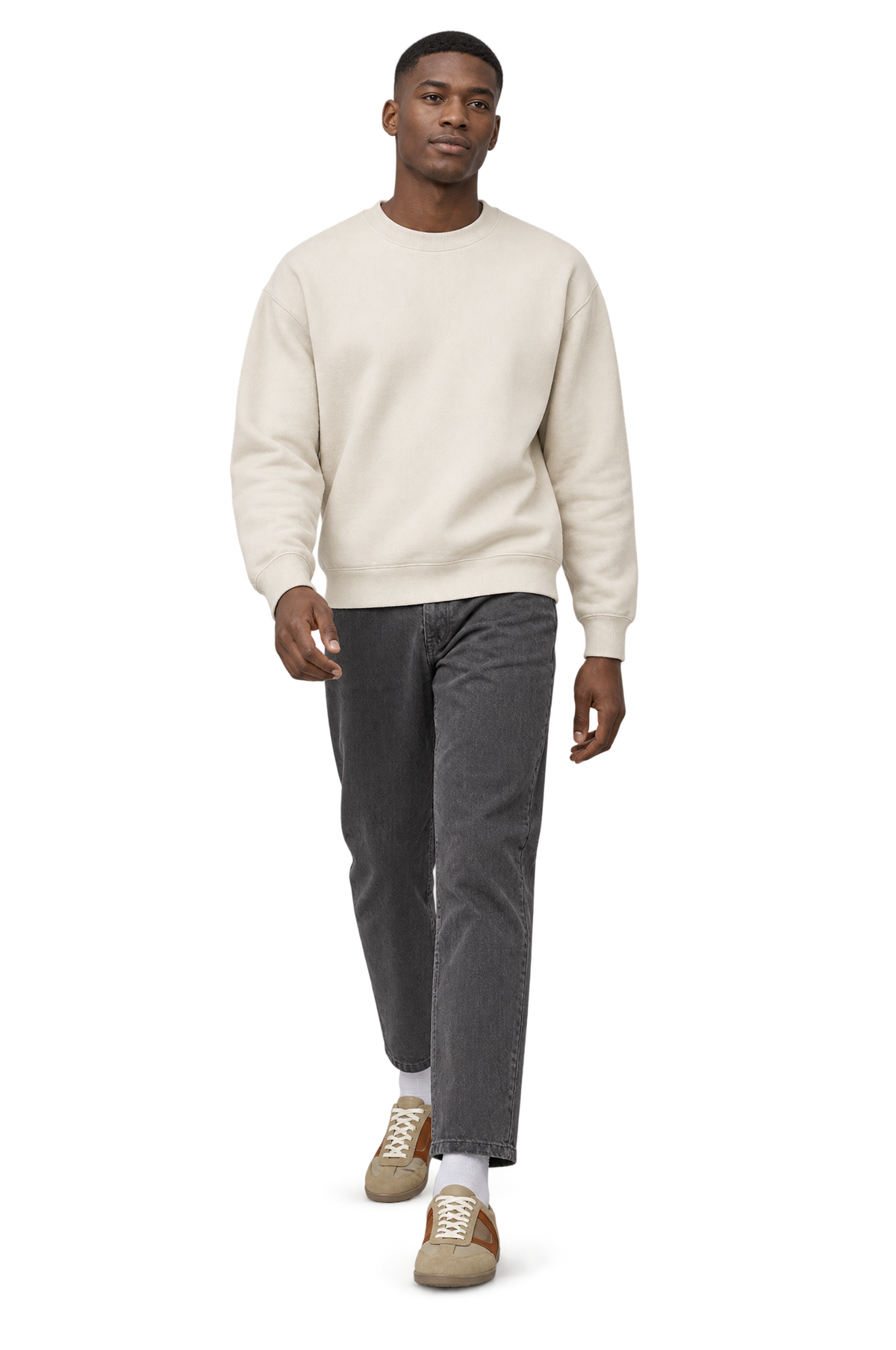 Man walking in HOS ARLO sneakers in Beige / Brown with an ecru sweatshirt and charcoal trousers