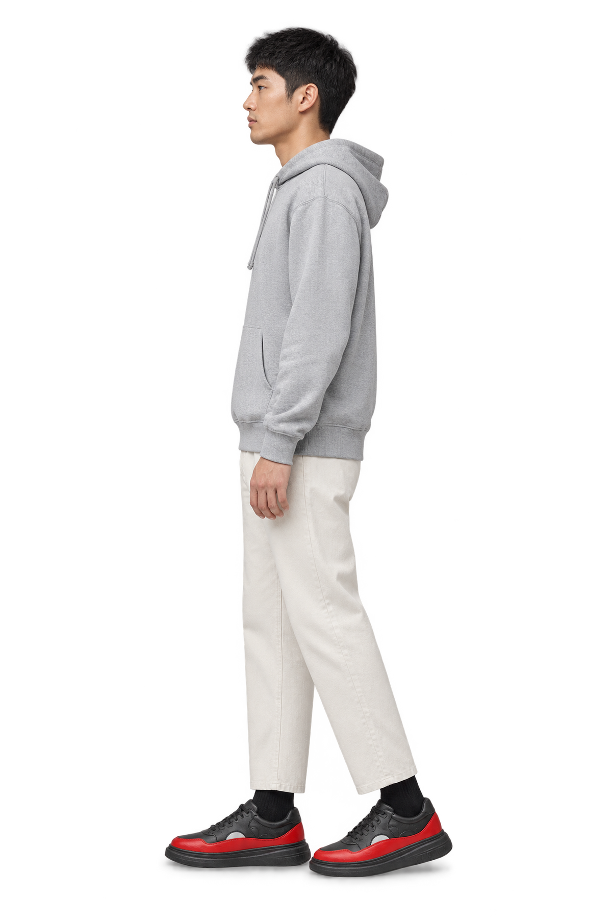 Side profile of a man wearing HOS CLOUD STEP sneakers in Black / Red with a grey hoodie and off-white trousers