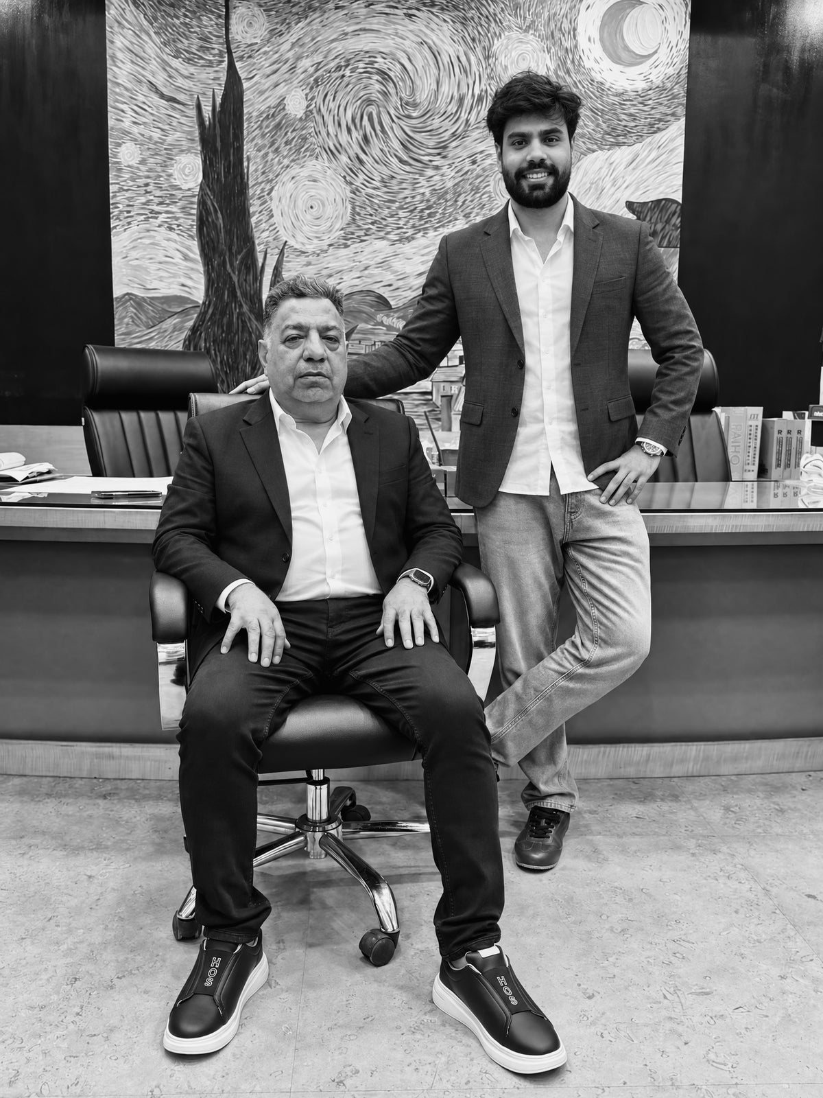 The founders of HOS in the office, both wearing HOS sneakers