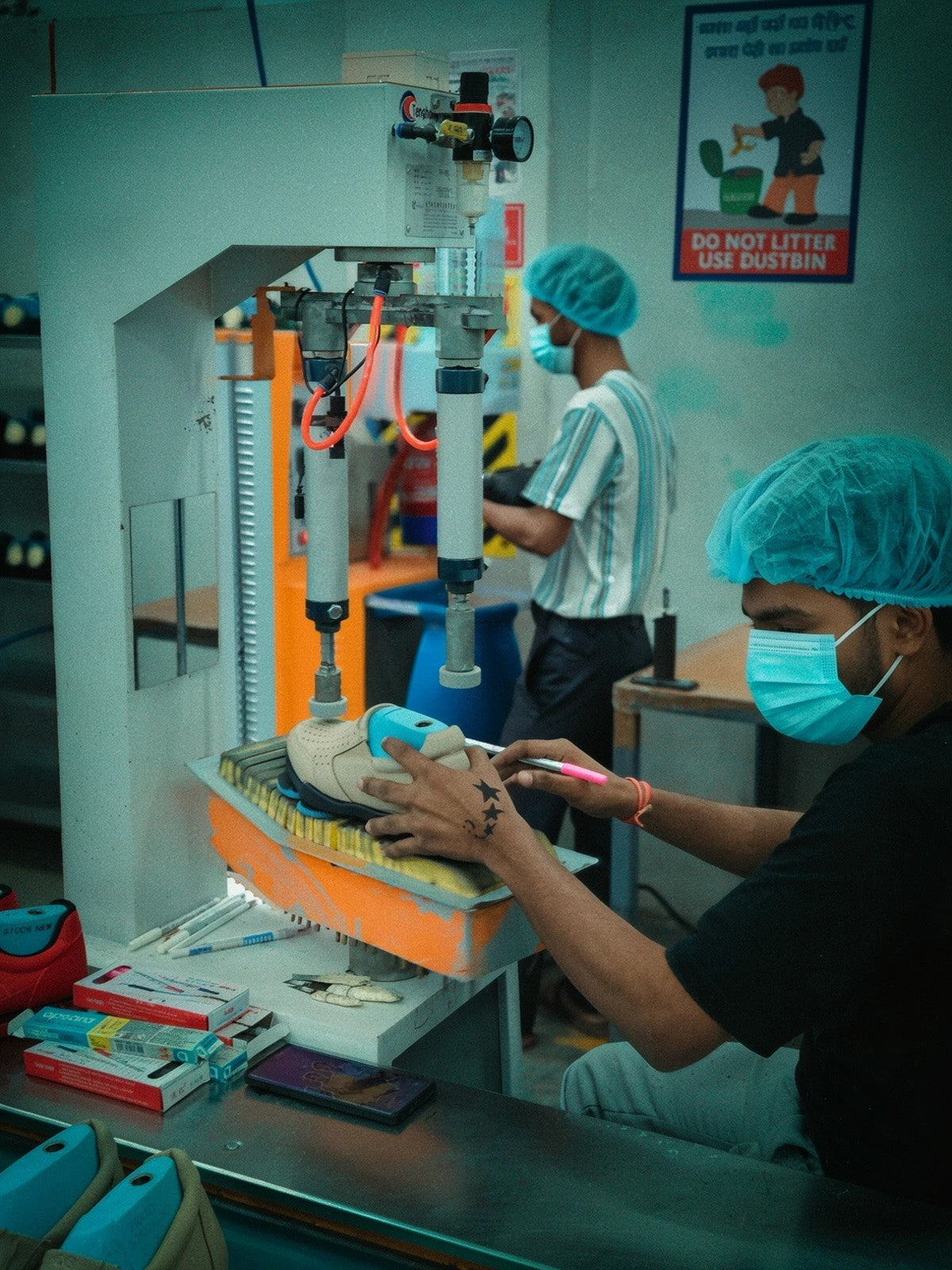 Craftsman marking a sneaker on the sole press